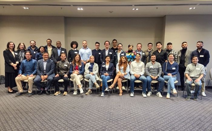 Fotografía de un grupo de 30 personas en dos filas, una sentados, sonriendo formalmente.