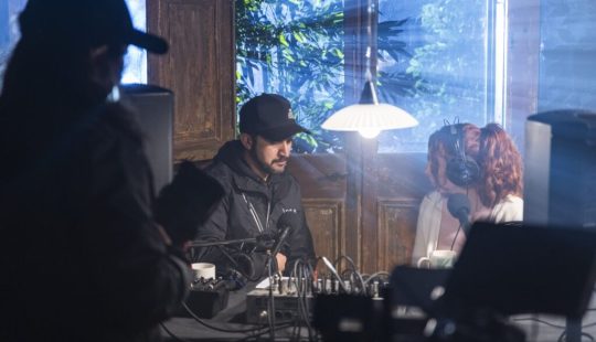 Fotografía de Bárbara Saavedra frente a una mesa de sonido con audífonos