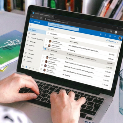 Fotografía de una persona en un computador en su mail Outlook